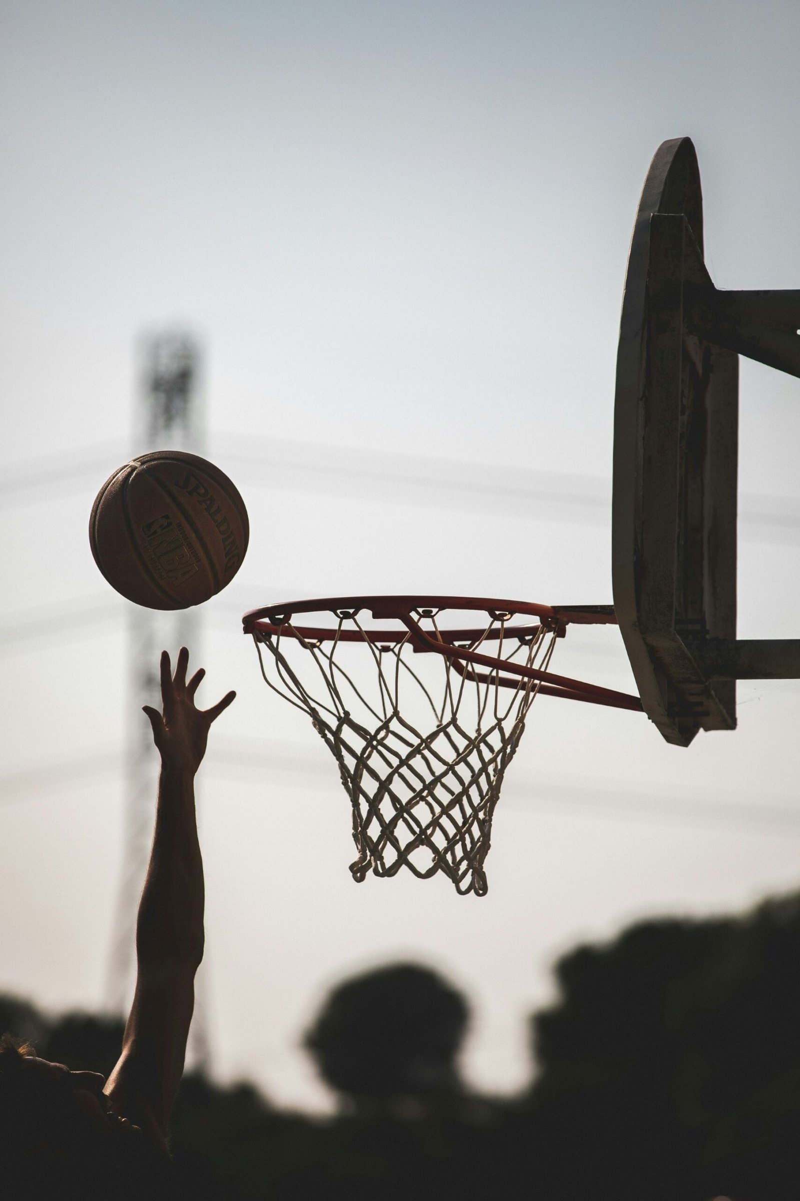 A young basketball player shooting the ball toward the hoop during a game